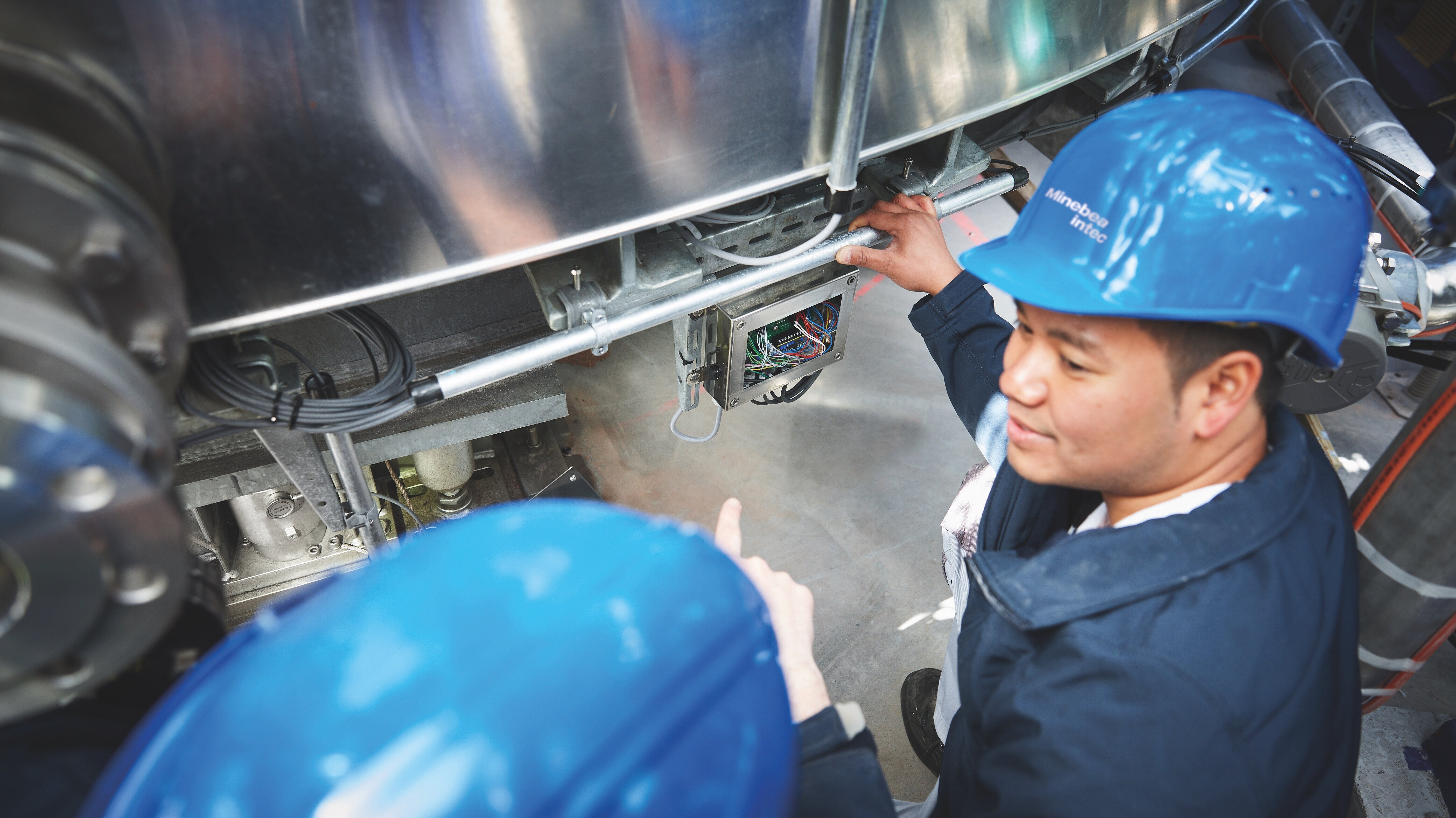 Two technicians investigating a machine