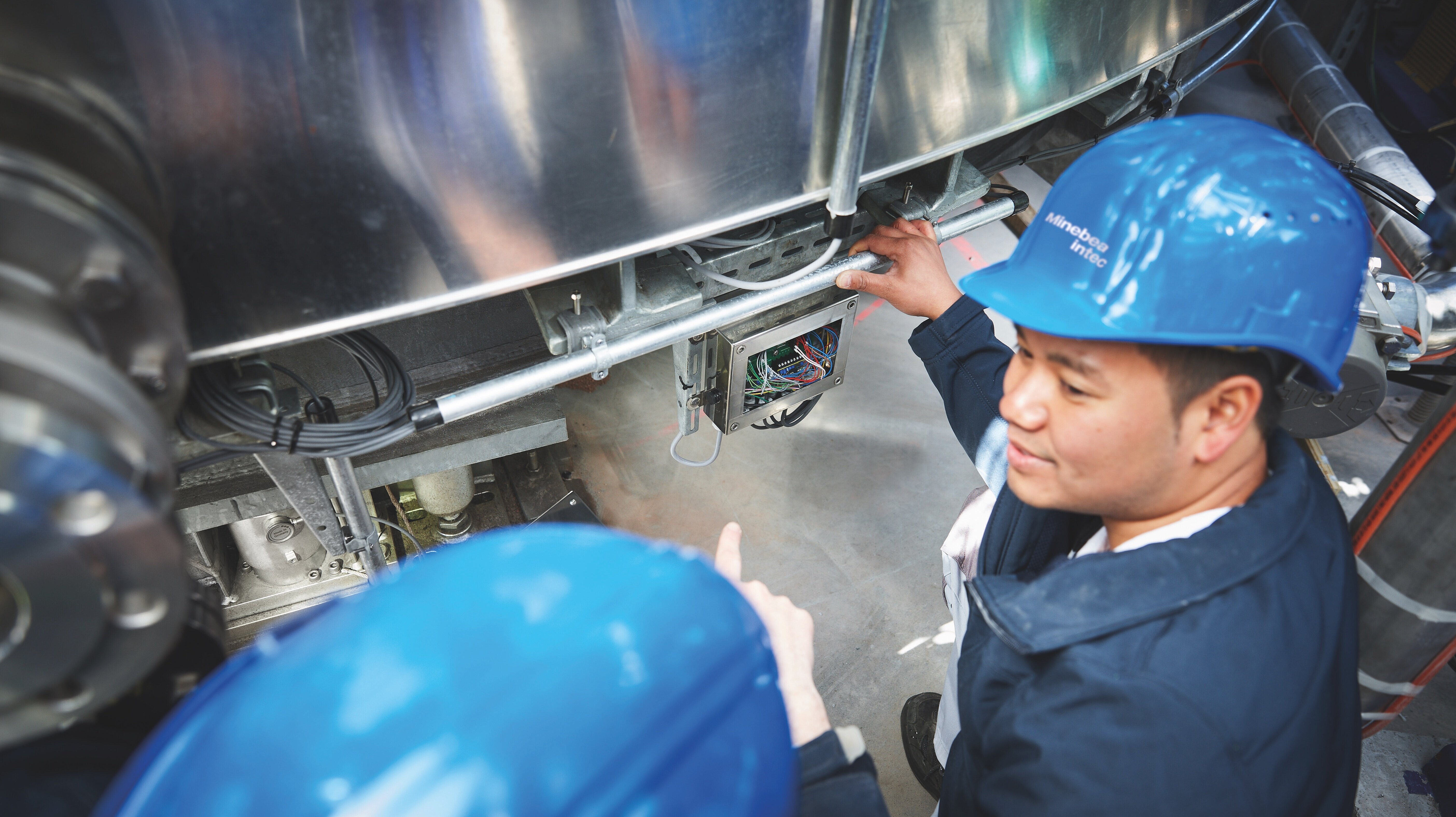 Two technicians investigating a machine