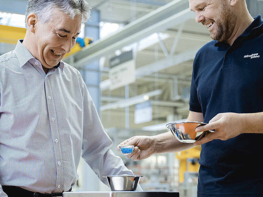 Two people using a scale