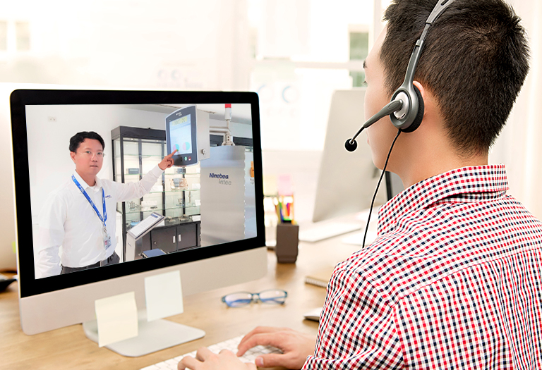 Man with a headset in front of a computer attending a virtual tour